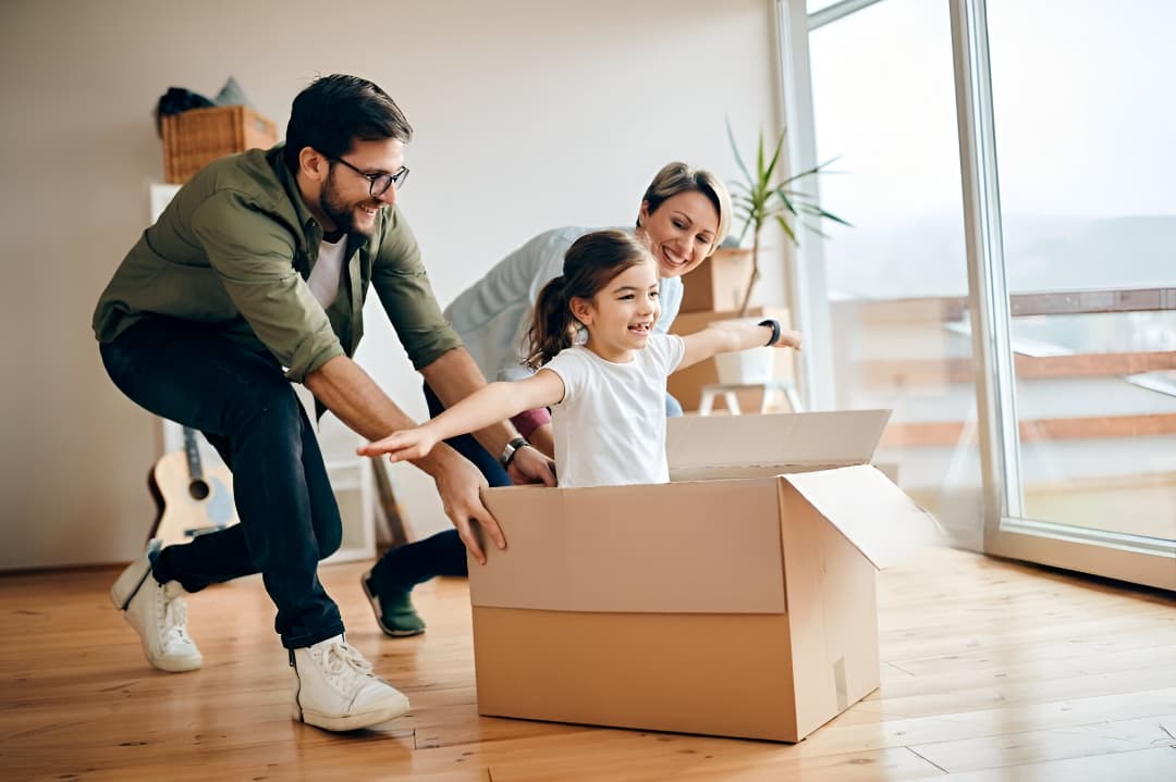 Family of three - man, woman, and young girl smiling together